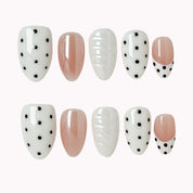 Porcelain Dot Muse press-on nail set in Black, White, Nude, Silver with white, nude and black design with polka dots and raised texture on a white background