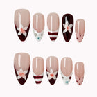 Burgundy Bow Sonata press-on nail set in Red, Nude, White, Pink with deep red French tip design with white bows, stripes and polka dots on a white background