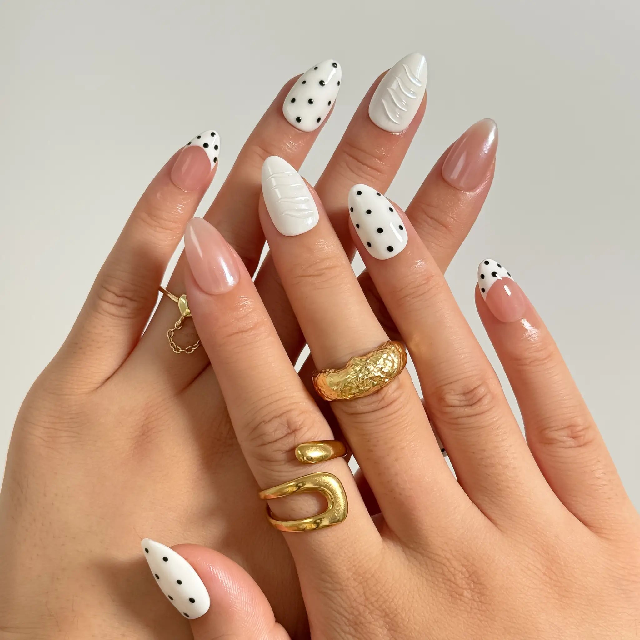 Porcelain Dot Muse medium almond press-on nails worn on hands, view 1