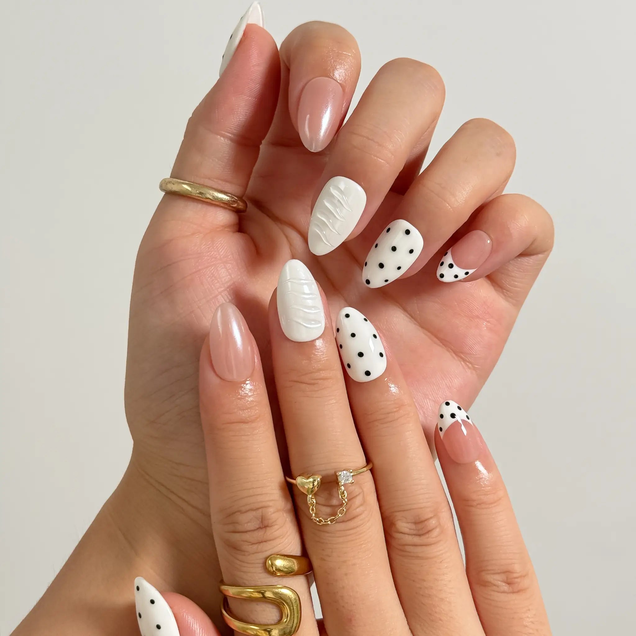 Porcelain Dot Muse medium almond press-on nails worn on hands, view 2