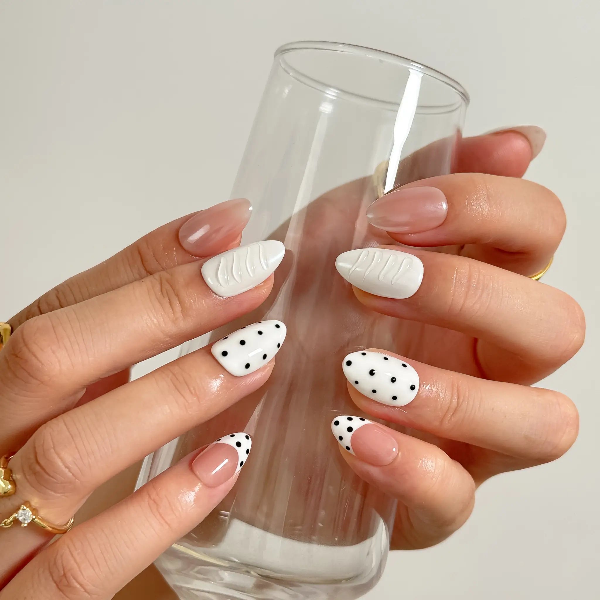 Porcelain Dot Muse medium almond press-on nails worn on hands, view 3