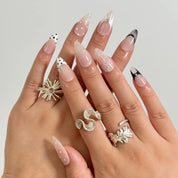 Noir Lace Whisper long almond press-on nails worn on hands, view 1