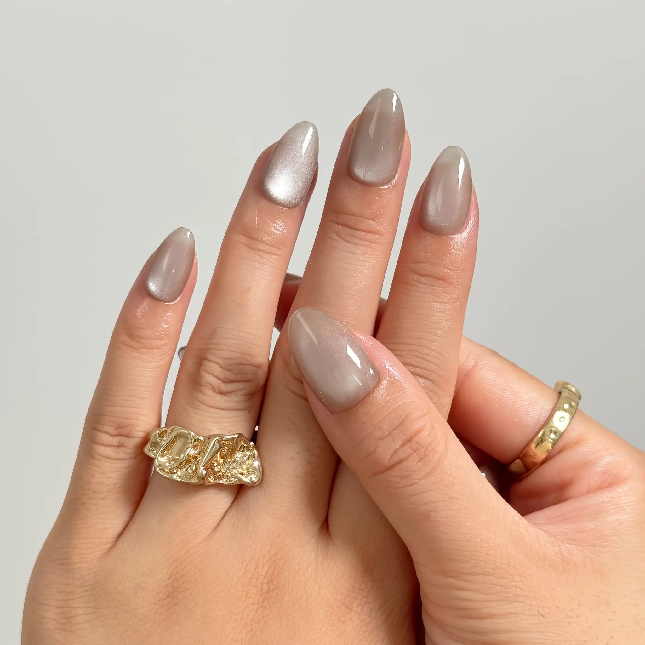 Silver Taupe Halo medium almond press-on nails worn on hands, view 3