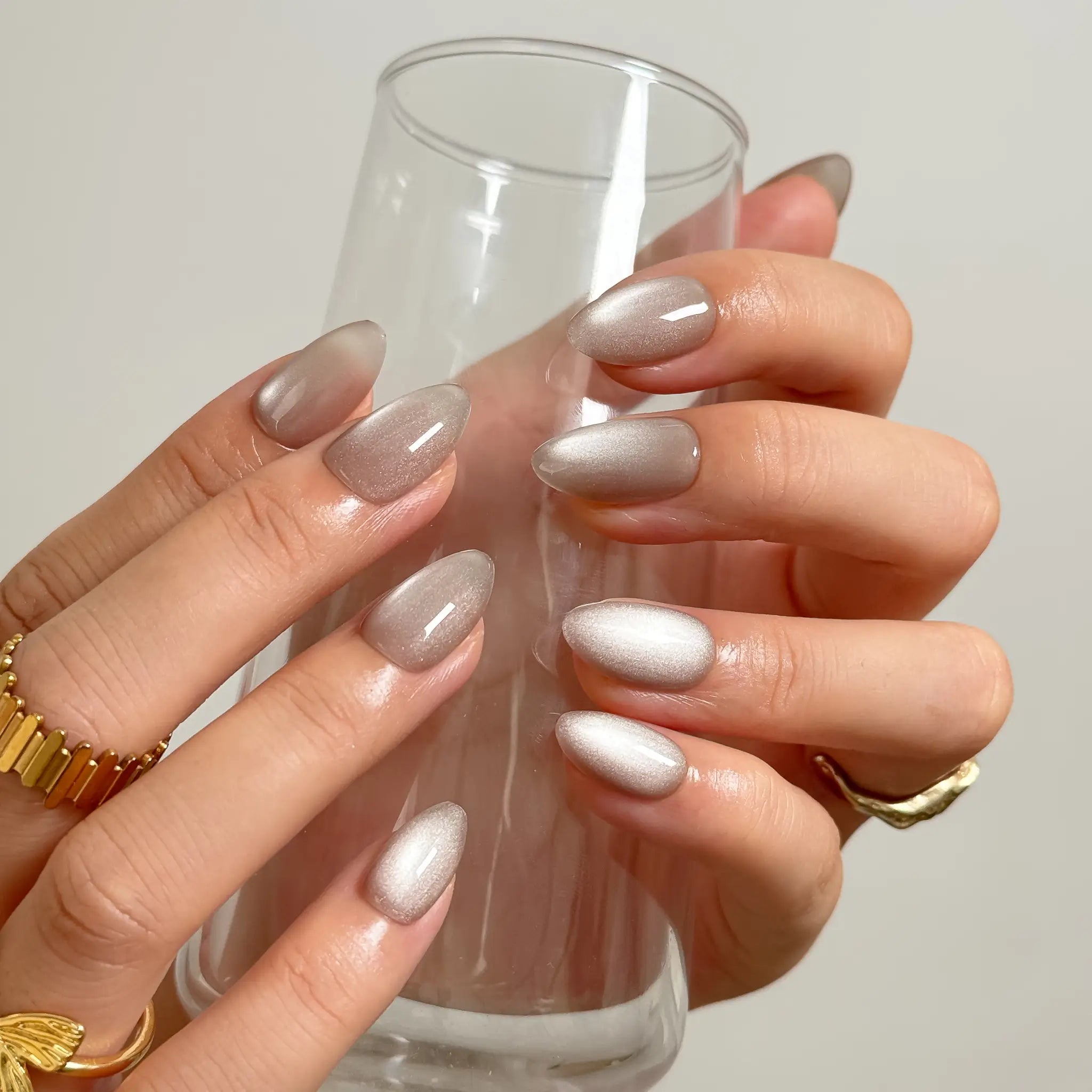 Silver Taupe Halo medium almond press-on nails worn on hands, view 4