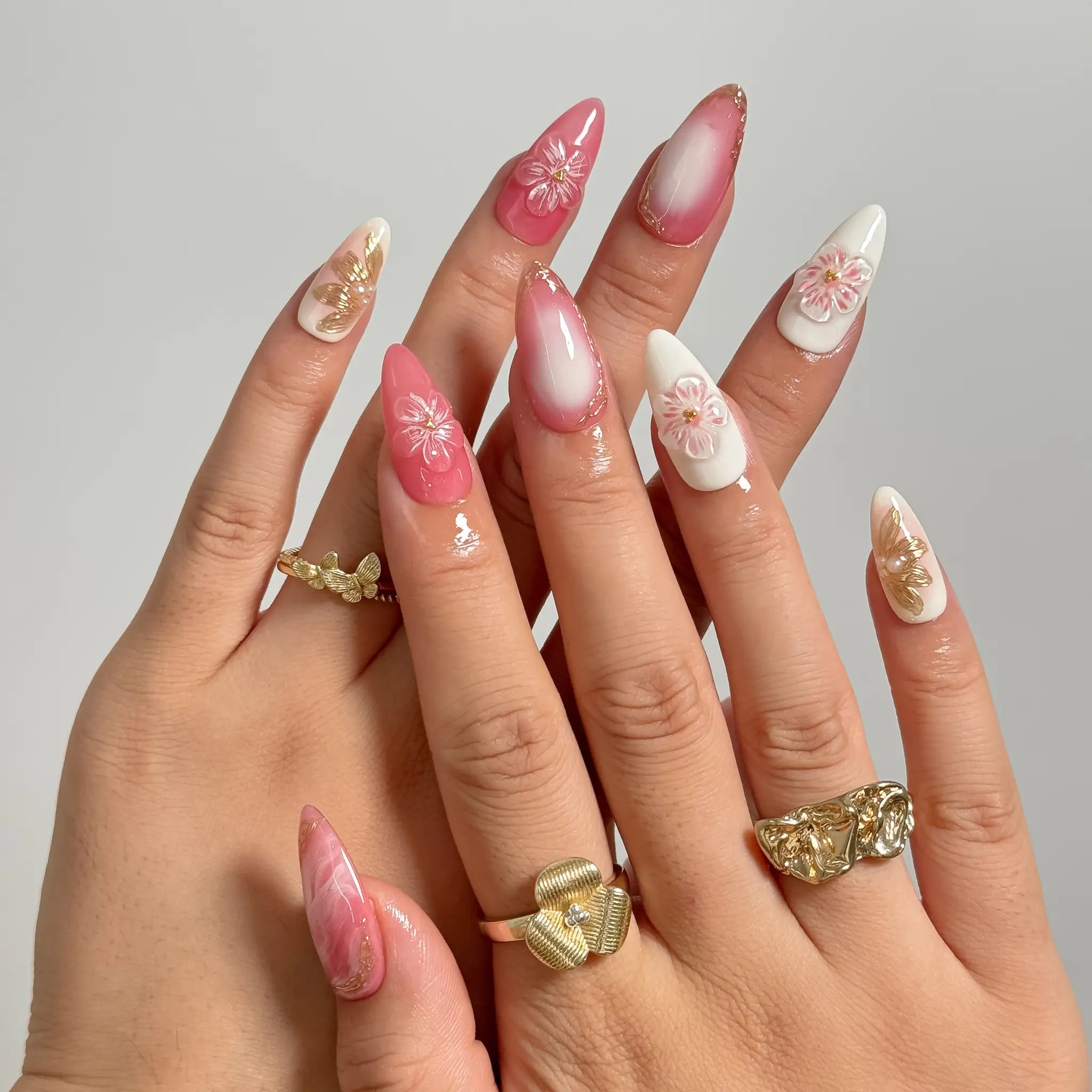 Blush Petal Veil medium almond press-on nails worn on hands, view 1