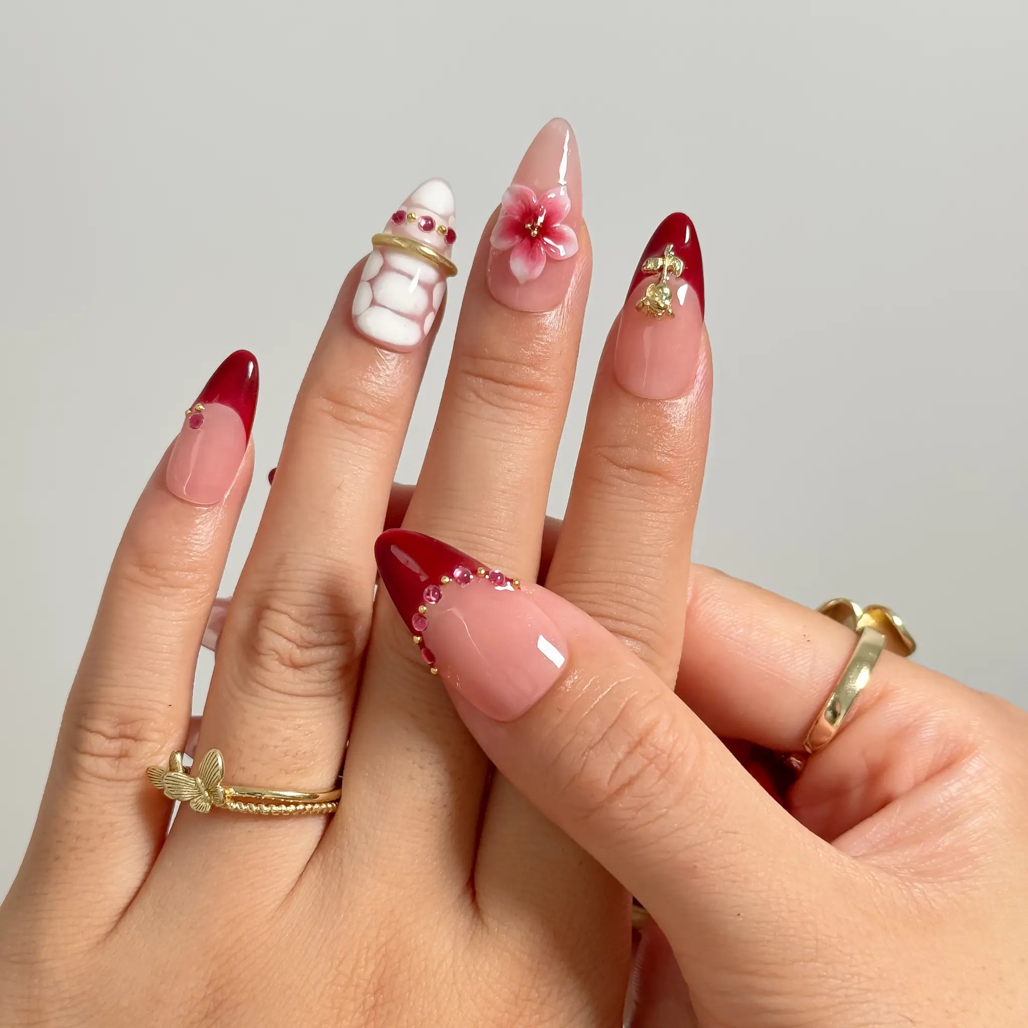 Crimson Garden Jewel medium almond press-on nails worn on hands, view 3