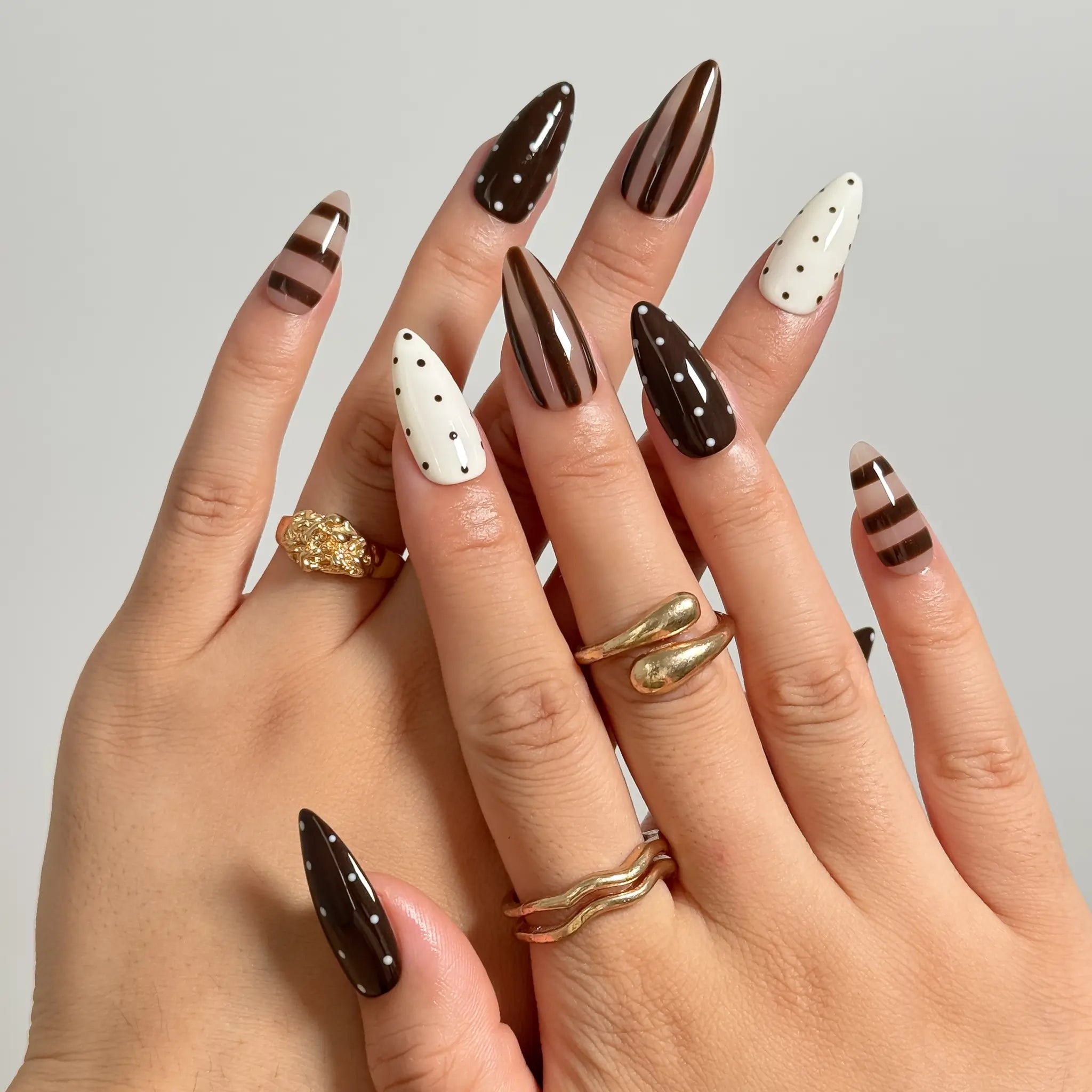 Cocoa Dot Rhythm medium almond press-on nails worn on hands, view 1