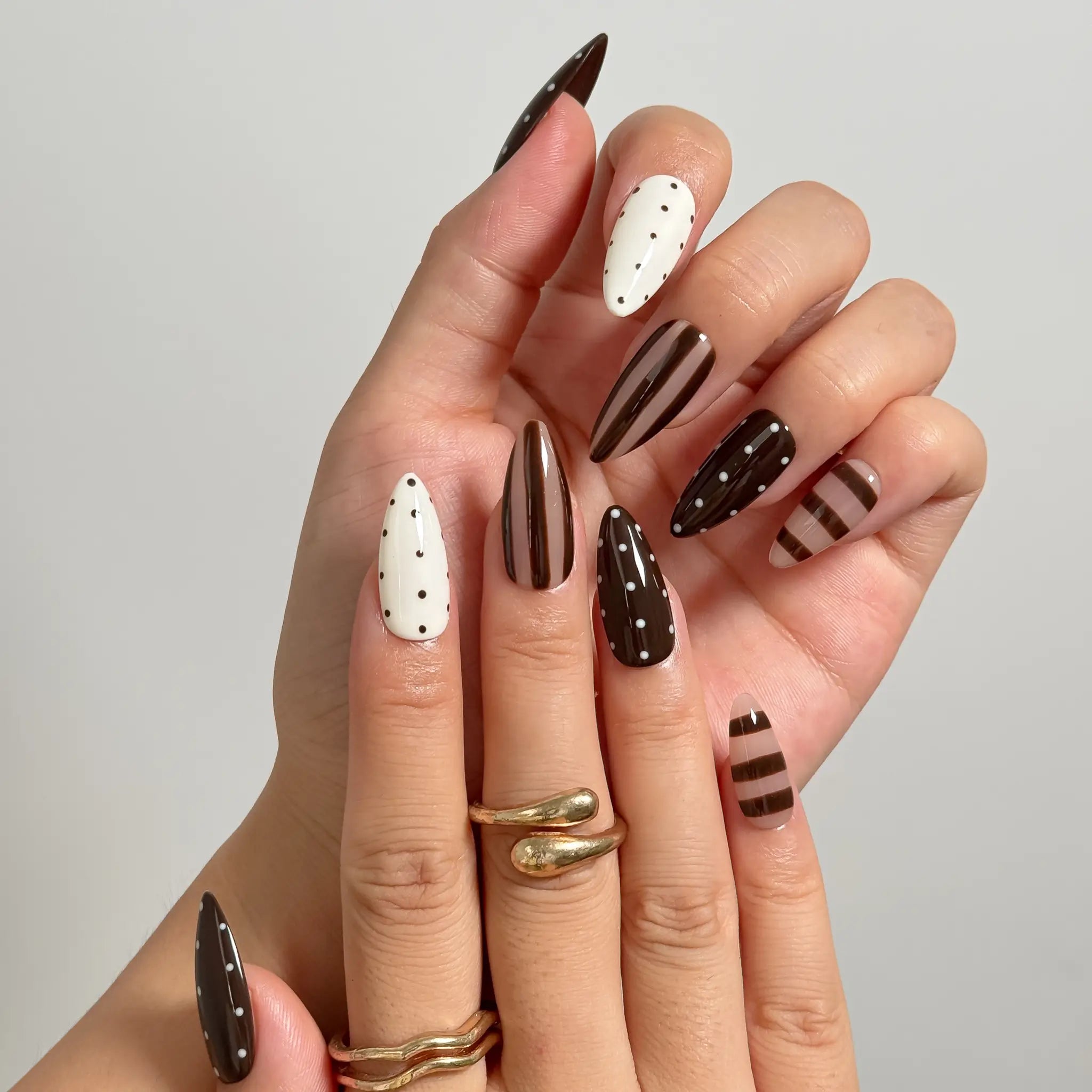 Cocoa Dot Rhythm medium almond press-on nails worn on hands, view 2
