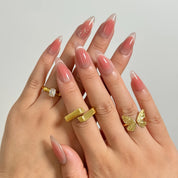 Roseglass Star Aura long almond press-on nails worn on hands, view 1
