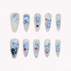 Shenlong's Cobalt Pearl pale almond nails with blue dragon-like motifs, white flowers, red accents and pearly details.